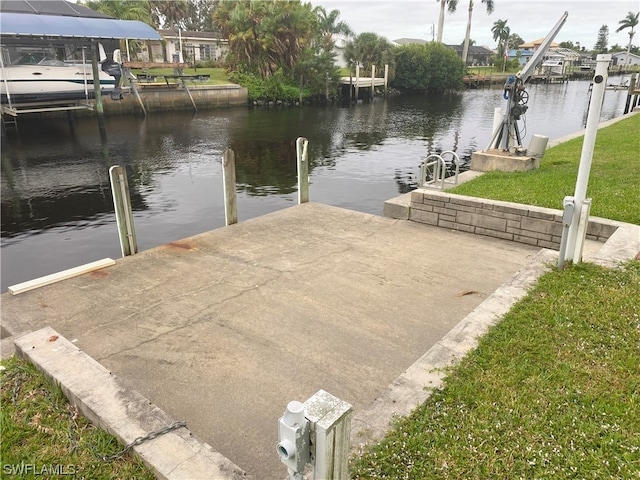 dock area with a yard and a water view