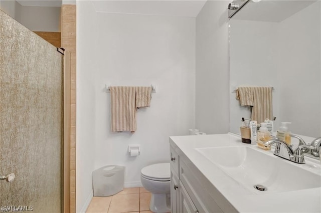 bathroom with tile patterned flooring, a shower with door, toilet, and vanity