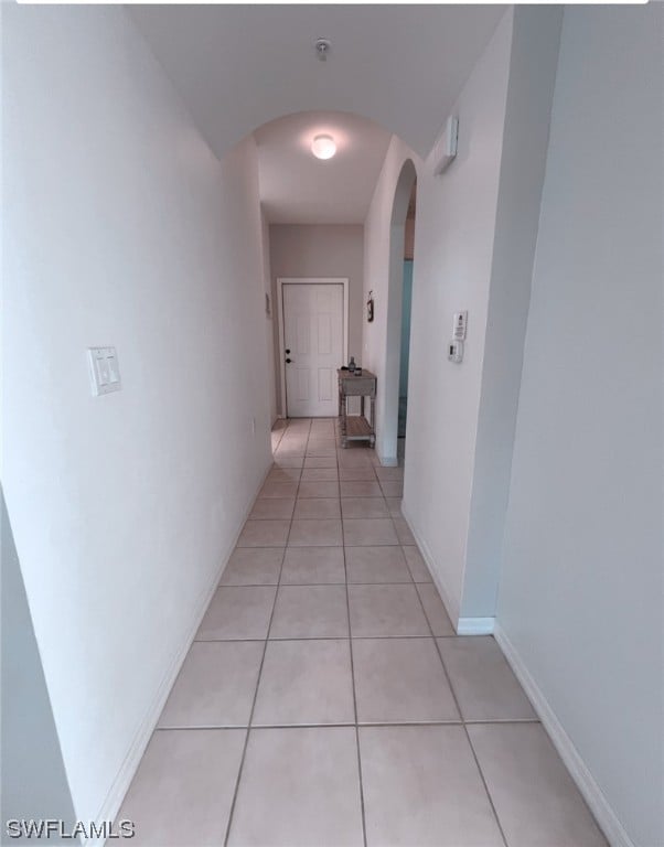 corridor featuring light tile patterned flooring