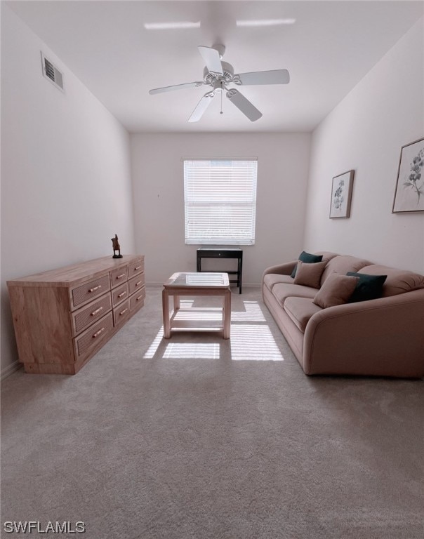 living room featuring carpet and ceiling fan