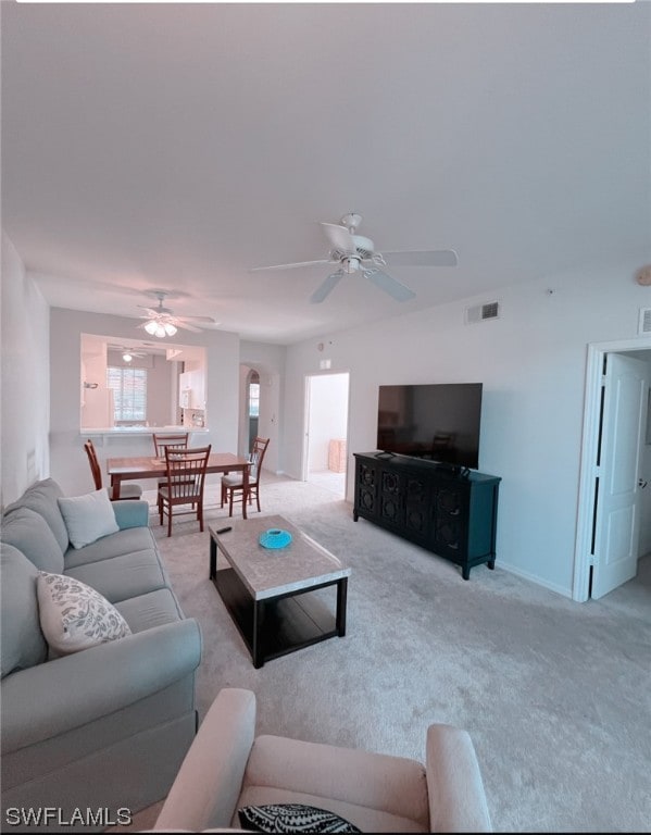 carpeted living room featuring ceiling fan