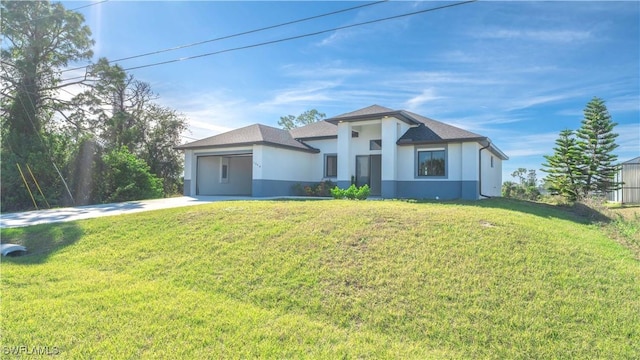 view of front of property featuring a front lawn and a garage