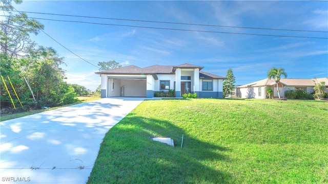 view of front of house featuring a front yard and a garage