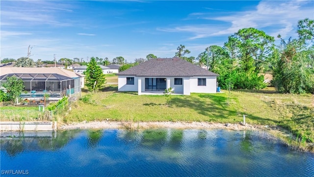 3340 NE 19th Ave, Cape Coral, FL 33909 - rear view of house featuring glass enclosure, a lawn, and a water view