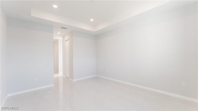 empty room with a raised ceiling