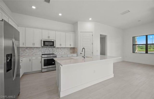 kitchen with white cabinets, sink, a kitchen island with sink, and appliances with stainless steel finishes