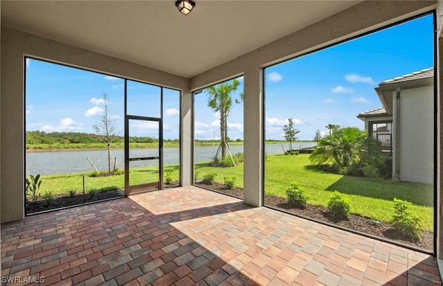 unfurnished sunroom with a water view