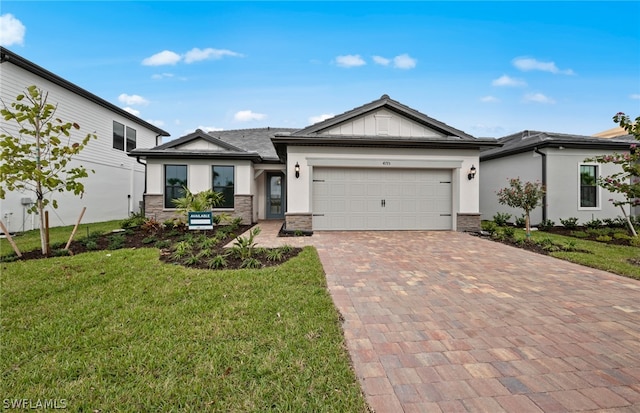 view of front facade with a front yard and a garage