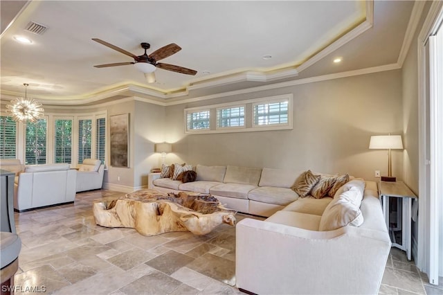 living room with a wealth of natural light, crown molding, and ceiling fan with notable chandelier