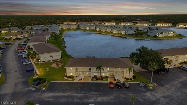 aerial view at dusk with a water view