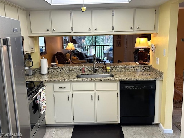 kitchen featuring light tile patterned flooring, appliances with stainless steel finishes, light stone counters, and sink