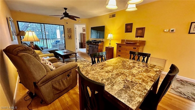 dining area featuring ceiling fan and light hardwood / wood-style flooring