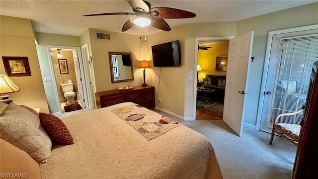 carpeted bedroom with ceiling fan and ensuite bathroom