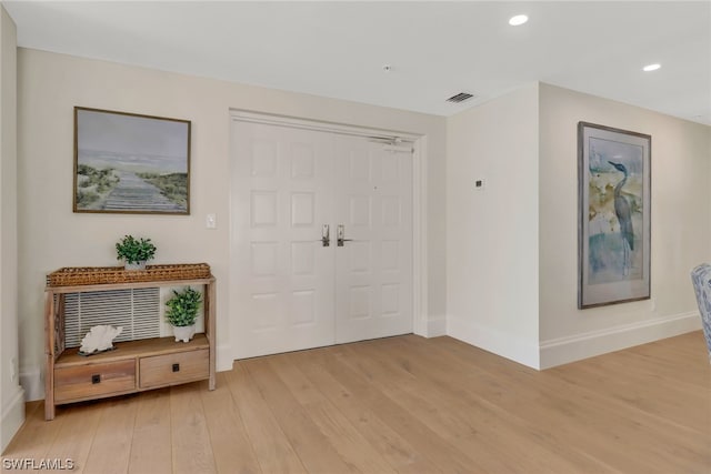 entryway with hardwood / wood-style floors