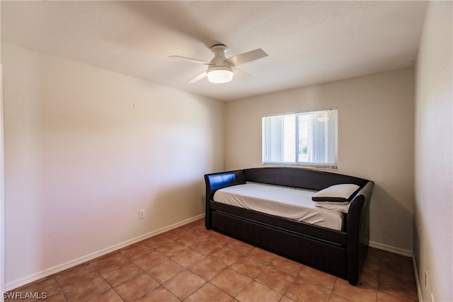 tiled bedroom featuring ceiling fan