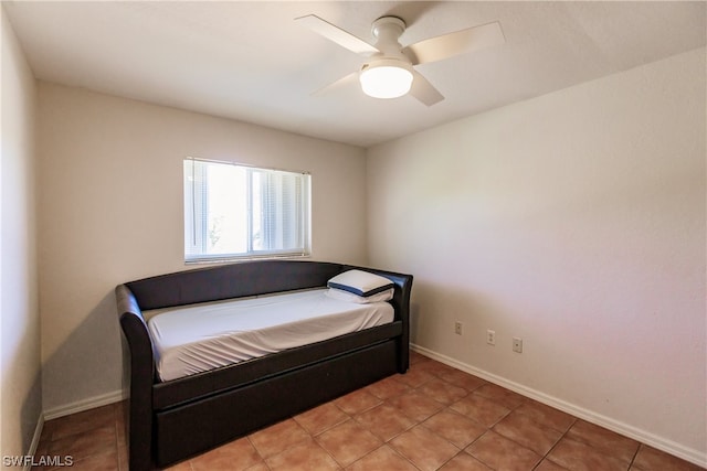 tiled bedroom featuring ceiling fan