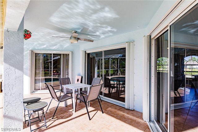 sunroom / solarium featuring ceiling fan