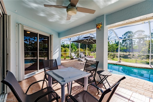 sunroom / solarium with a healthy amount of sunlight and ceiling fan