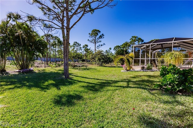 view of yard featuring glass enclosure