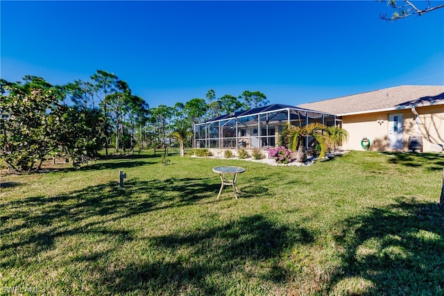 view of yard with glass enclosure