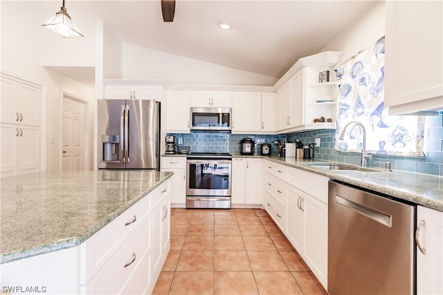 kitchen featuring pendant lighting, sink, white cabinetry, appliances with stainless steel finishes, and vaulted ceiling