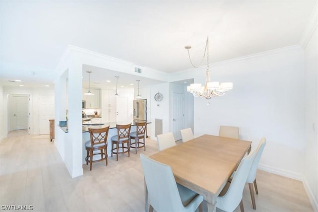 dining space with crown molding, a chandelier, and light wood-type flooring