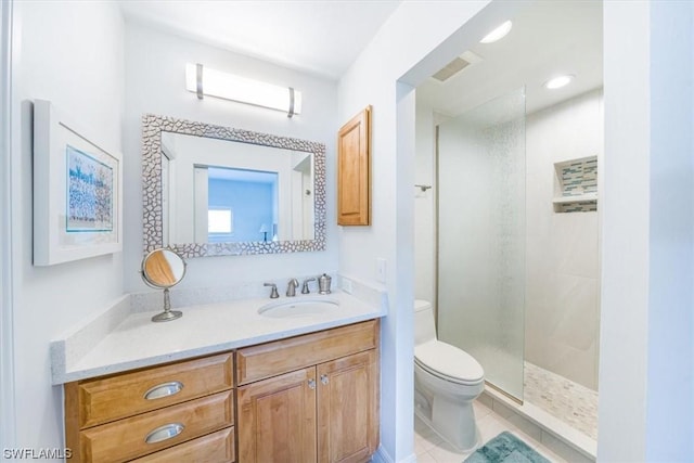 bathroom with vanity, toilet, and a shower with door