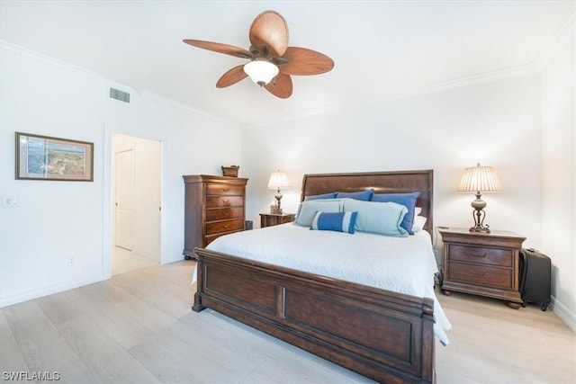 bedroom featuring crown molding, ceiling fan, ensuite bathroom, and light wood-type flooring