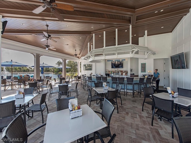 view of patio / terrace featuring a bar and ceiling fan