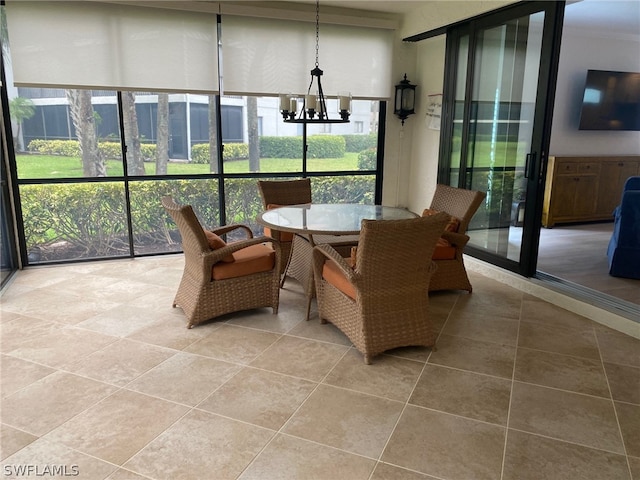 sunroom featuring a chandelier