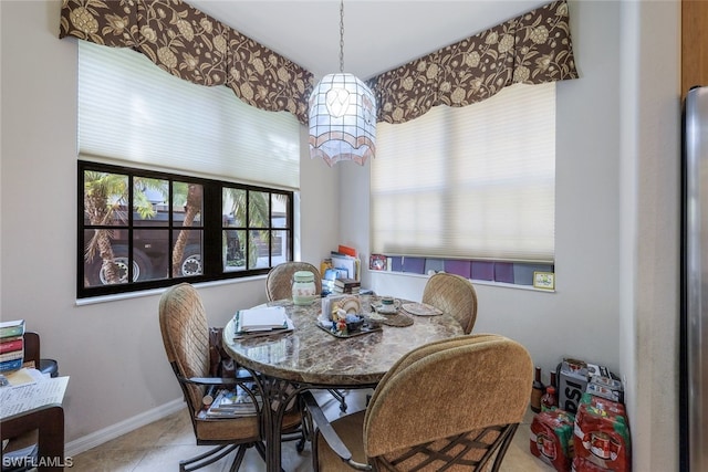 dining space featuring light tile floors