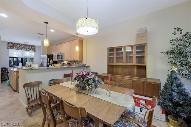 dining space featuring light tile floors