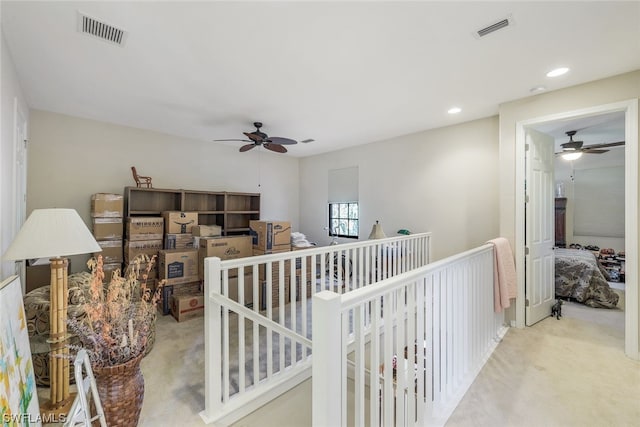 interior space featuring light carpet and ceiling fan