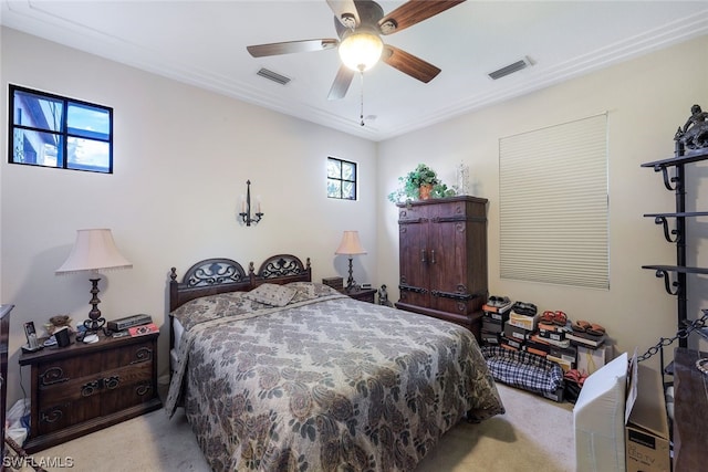 carpeted bedroom featuring ceiling fan and multiple windows