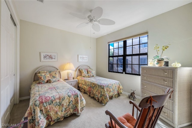 carpeted bedroom with a closet and ceiling fan