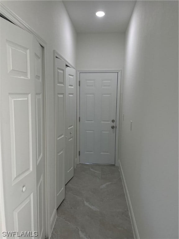 corridor with dark tile floors