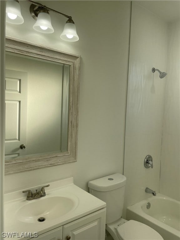 full bathroom featuring toilet, vanity with extensive cabinet space, and tub / shower combination