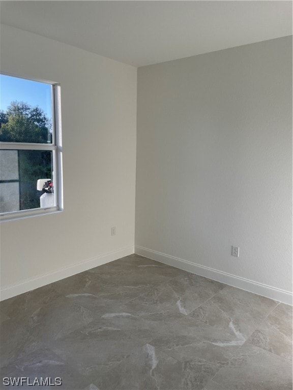 unfurnished room with light tile floors