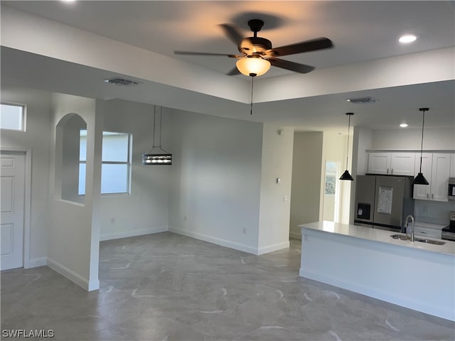 kitchen with ceiling fan, appliances with stainless steel finishes, sink, light tile floors, and white cabinets