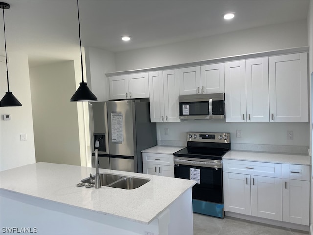 kitchen with white cabinetry, hanging light fixtures, appliances with stainless steel finishes, sink, and light tile floors