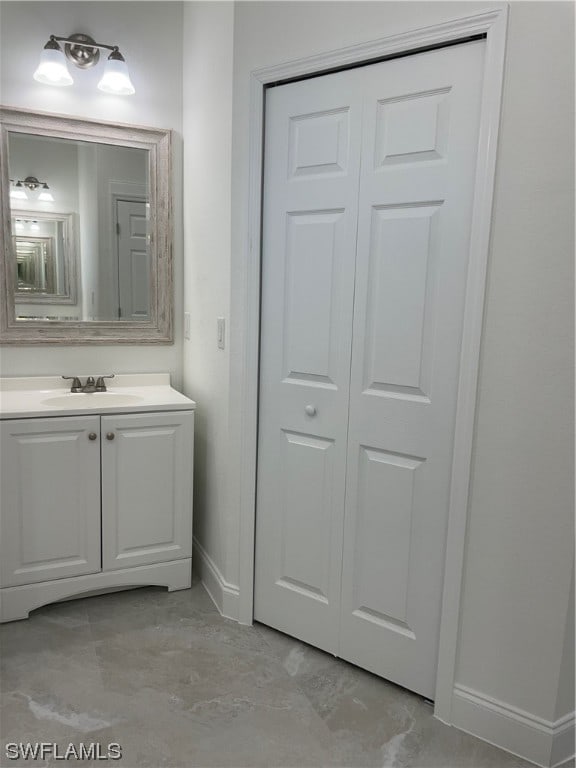 bathroom with vanity with extensive cabinet space and concrete flooring