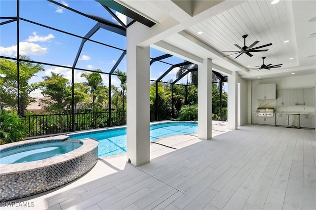 375 Periwinkle Ct, Marco Island, FL 34145 - view of pool with a ceiling fan, a pool with connected hot tub, an outdoor kitchen, and glass enclosure