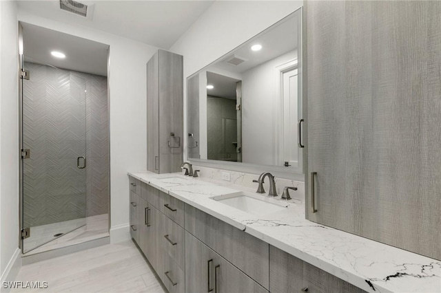 375 Periwinkle Ct, Marco Island, FL 34145 - full bath with double vanity, visible vents, a stall shower, and a sink