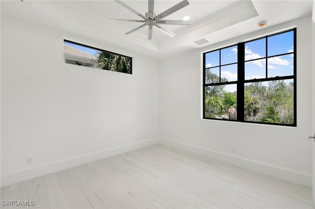 375 Periwinkle Ct, Marco Island, FL 34145 - spare room featuring a raised ceiling, baseboards, plenty of natural light, and visible vents