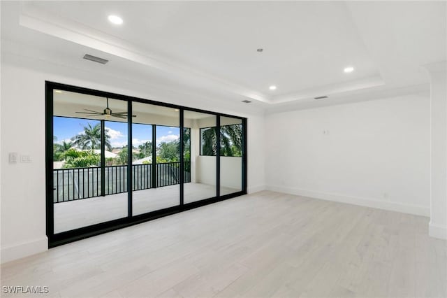375 Periwinkle Ct, Marco Island, FL 34145 - spare room featuring a raised ceiling, baseboards, light wood-type flooring, and visible vents