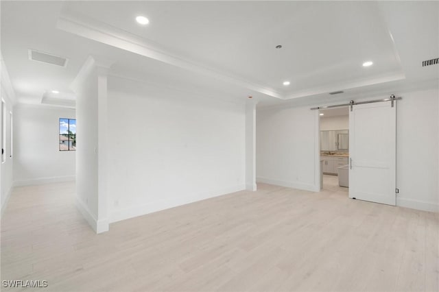 375 Periwinkle Ct, Marco Island, FL 34145 - spare room with a raised ceiling, a barn door, baseboards, and visible vents