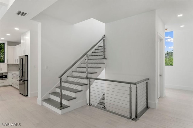 375 Periwinkle Ct, Marco Island, FL 34145 - stairs with wood finished floors, baseboards, visible vents, and recessed lighting