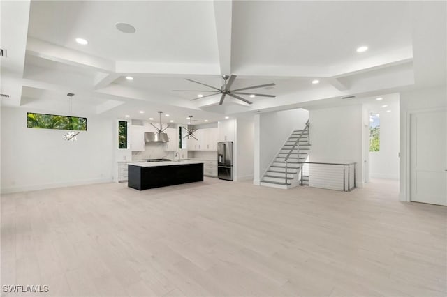 375 Periwinkle Ct, Marco Island, FL 34145 - unfurnished living room featuring light wood finished floors, a ceiling fan, stairway, baseboards, and recessed lighting
