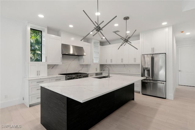 375 Periwinkle Ct, Marco Island, FL 34145 - kitchen featuring wall chimney range hood, decorative backsplash, high end fridge, and a sink