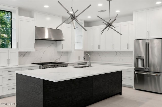 375 Periwinkle Ct, Marco Island, FL 34145 - kitchen featuring a sink, light wood-type flooring, white cabinetry, range hood, and high end refrigerator